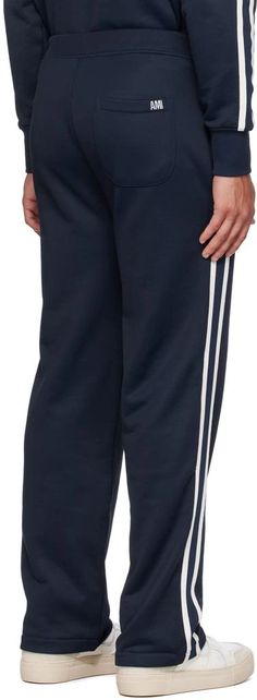 AMI Paris.SSENSE Exclusive Navy Track Pants.Nylon- and cotton-blend French terry track pants..· Concealed drawstring at elasticized waistband.· Three-pocket styling.· Stripes at outseams.· Embroidered logo patch at back pocket.Available exclusively at SSENSE..Supplier color: Lazuli blue.60% polyamide, 40% cotton..Made in Bulgaria..231482M190009 Navy Sporty Sweatpants With Elastic Waistband, Sporty Navy Sweatpants With Elastic Waistband, Sporty Relaxed Fit Sweatpants With Side Stripes, Sporty Loungewear Pants With Side Stripes, Navy Sporty Sweatpants With Pockets, Sporty Bottoms With Elastic Cuffs And Straight Hem, Navy Athleisure Sweatpants With Pockets, Sporty Straight Leg Sweatpants With Side Stripes, Athleisure Trousers With Side Stripes