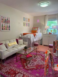 a living room filled with lots of furniture and decor on top of a pink rug