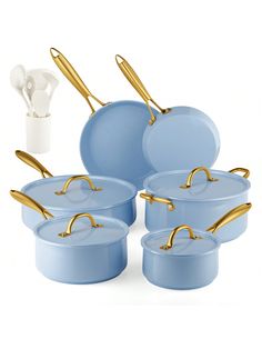 a set of blue pots and pans with gold handles are shown in front of a white background