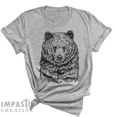 Our original Bear art from our wildlife series. Limited Prints available, unisex sizing. Made in USA. Bella + Canvas 3001C Unisex Jersey T-Shirt, (breathable, soft, lightweight, and durable) Style: 3001C Fabric Weight: 4.2 oz Sizes: S, M, L, XL, 2XL Check out more design on our site: ImpastoCreative(dot)com Features: 4.2 oz., 100% airlume combed and ringspun cotton, 32 singles retail fit unisex sizing shoulder taping side-seamed tear away label pre-shrunk Animal T Shirt, Bear Drawing, Bear Art, Animal Tshirt, Animal Shirts, Shoulder Taping, Art Gift, Bella Canvas, Unisex T Shirt