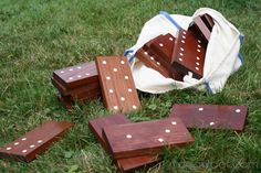 several pieces of wood sit on the ground in front of a white bag with polka dots