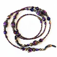 "Iridescent Purple Beaded Eyeglass Chain. Variety of faceted Czech glass beads with an AB finish, this gives the beads a rainbow effect. The lanyard is accented with antiqued brass filigree bead caps create a vintage look. I completed the lanyard with Czech glass seed beads with eyeglass connectors. Show off your unique sense of style when you wear this wonderful eyeglass chain. FEATURES > Total length 26\", may be adjusted upon request > Your choice of eyeglass connectors, skinny arm or wide arm. > To ensure long lasting wear I use professional quality beading wire (49 strand). The beading wire is very strong and flexible, providing a soft drape and it lays softly on the neck for maximum. Wire guardians are incorporated to protect wire from wear. The wire is double crimped for a secure ho Beaded Eyeglass Chain, Eyeglass Necklace, Iridescent Purple, Brass Filigree, Purple Beaded, Beaded Lanyards, Eyeglass Chain, Glasses Chain, Beading Wire