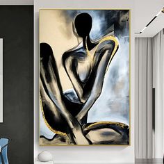 an abstract painting hangs on the wall in a modern living room with blue chairs and white walls