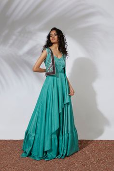 Aqua layered anarkali gown paired with a cropjacket embroidered with thread, tubes, pearls, beads & mirrors. Indulge in the captivating allure of Aqua Gown. This layered anarkali gown is thoughtfully paired with a delicate cropjacket adorned with exquisite thread, tubes, pearls, beads, and mirrors. Elevate your style with this statement piece that exudes elegance and sophistication. Colour : AQUA Fabric : CREPE Embroidery details : HAND EMBROIDERY Components : 2 Wash Care : DRY CLEAN ONLY Delive Aqua Gown, Beaded Mirror, Aqua Fabric, Anarkali Gown, Greek Fashion, Embroidery Details, Crop Jacket, Anarkali, Hand Embroidery