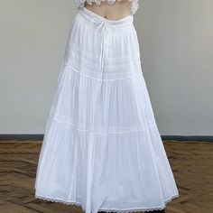 Elevate your style with our White Coquette Lace Tiered Maxi Skirt. This tiered design adds dimension and flow, complemented by the high waist that elongates the silhouette. The delicate lace trim and luxurious white tone make this skirt a statement piece, perfect for a sophisticated wardrobe. It's crafted with a blend of polyester and spandex for both style and comfort. Ideal for those seeking a chic addition to their closet. Tiered design High waist Delicate lace trim Luxurious white tone Blend Summer Daywear Waist-length Skirt, Waist-length Summer Skirt For Daywear, Waist-length Skirt For Summer Daywear, Sophisticated Wardrobe, White Coquette, Long Skirt Summer, White Long Skirt, White Midi Skirt, White Tone