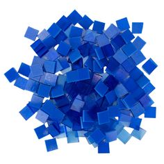 a pile of blue glass tiles sitting on top of a white table