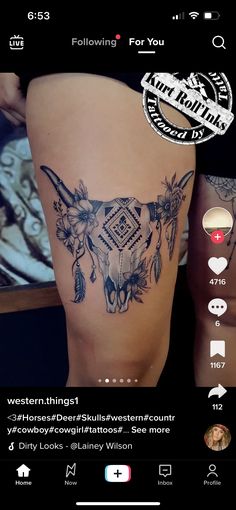 the back of a woman's thigh with tattoos on it and an image of a cow