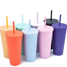 six different colored cups with straws and lids on the bottom, in front of a white background