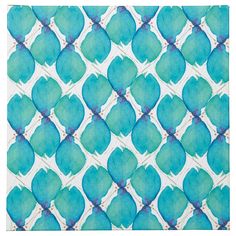 a blue and white tile with leaves on the bottom, in an abstract pattern that looks like it has been made out of paper