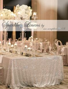 the table is set up with candles and centerpieces for an elegant wedding reception