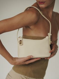 Ivory Twister Hobo Bag - Verafied New York Classic Cream Rectangular Hobo Bag, Modern Cream Hobo Bag With Adjustable Strap, Cream Hobo Bag With Zipper Closure, Eco-friendly Cream Hobo Shoulder Bag, White Hobo Bag With Gold-tone Hardware, Hobo Shoulder Bag, Togo Leather, Hobo Bag, Bag Sale