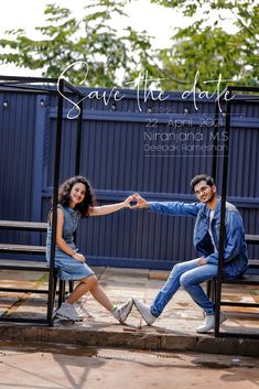 a man and woman sitting on a bench in front of a fence with the words save the date