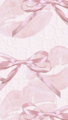 a pink wallpaper with bows on it