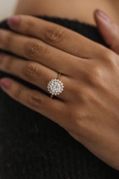 a woman's hand with a diamond ring on it