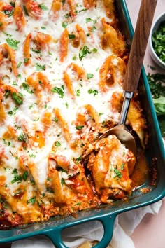 a casserole dish with meat, cheese and sauce in it on a table