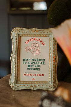 there is a sign on the table that says help yourself to sparkler brush outside