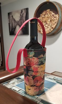 "This unique Single Bottle Wine Tote is made with a cork fabric that I imported from Canada. It has a printed Grunge Circles in multiple colors and features a red cotton webbing handle.  The size is approximately 7-1/2\" tall (16-1/2\" tall with the handle) and will hold a wine bottle with a 10-3/4\" circumference that is a max of 13\" tall. NOTE: A bottle larger than 10-3/4\" circumference will put stress on the seam.  PLEASE NOTE; you are purchasing the single bottle wine tote only.  Anything in or around the wine tote is for display only.  Online images do not capture the actual vibrancy of the fabric colors. Cork fabric is a natural product which may have unique traits, such as darkened areas or slightly rough areas due to the nature of the product.   Real cork bark fused to a soft wov Bottle Corks, Wine Tote, Cork Fabric, Online Images, Wine Cork, Baby Wipes, Red Wine, Fabric Color, Cleaning Wipes