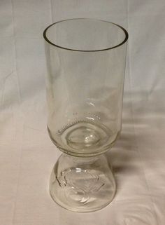 an empty glass sitting on top of a white table