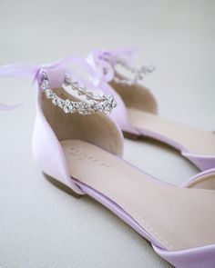 the bride's shoes are adorned with jewels