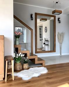 a living room filled with furniture and a large mirror