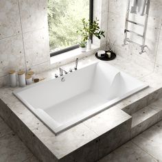 a white bath tub sitting next to a window