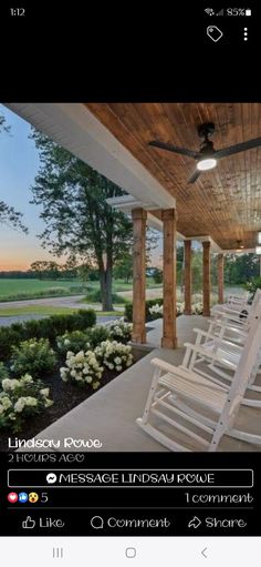 an image of a porch with chairs and flowers on the front lawn at sunset or dawn