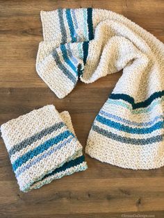 a crocheted hat and scarf on a wooden floor