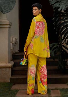 The lime yellow big floral co-ord set is inspired from fresh blooming spring flowers. The print has been converted from hand painted floral motifs into digital sketch and it has been printed using digital print technique. The set features a strappy blouse, straight cut trouser pants and we've paired it with shirt which is adorned using shell buttons. Paulmi And Harsh, Co Ord Sets Pants, Two Piece Sets Outfits, Strappy Blouse, Spring Floral Prints, 1950’s Fashion, Straight Cut Pants, Lime Yellow, Padded Blouse