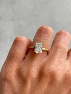 a woman's hand with a diamond ring on it