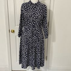 Navy Shirtdress With Daisy Print In White And Yellow. Shirt Collared, Buttons Down The Front. Tie Belt. 3/4 Length Cuffed Sleeves With Button Tabs. Beautiful Polyester Faille. This Is A New Item That Hasn’t Been Worn. No Tags Attached. Classic And Timeless. I Love This Dress And The Daisy Print, But It Is A Tad Small For Me. Casual Daywear Dresses 3/4 Length, Casual 3/4 Length Dresses For Work, Casual Blue Midi Dress With 3/4 Sleeves, Casual Floral Print Midi Dress, 3/4 Length, Cotton Daisy Print T-shirt With Relaxed Fit, Cotton Floral Print Button-up Shirt Dress, Print Shirt Dress, Yellow Shirt, Printed Shirt Dress