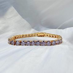 💎 5mm 18k Gold Plated Purple Moissanite Bracelet 💎 Certified VVS1 Moissanite: Meticulously selected stones for superior clarity and vibrant purple hue, akin to natural diamonds. 🌟 Made with 925 Sterling Silver & Triple-layer 18k Gold Plating: Provides a durable, lustrous finish that enhances the bracelet's luxurious appeal. ⚖️ Tennis Bracelet Design: Classic and versatile, suitable for everyday wear or as a statement piece for special occasions. 🎁 Perfect Gift: Ideal for both men and women w Purple Luxury Tennis Bracelet, Gold Moissanite Diamond Bracelet With Brilliant Cut, Gold Moissanite Bracelet For Formal Occasions, Gold Moissanite Diamond Bracelet For Formal Occasions, Gold Moissanite Jubilee Diamond Bracelet, Gold Moissanite Bracelets For Anniversary, Gold Moissanite Bracelet With Diamond Cut, Gold Round Moissanite Diamond Bracelet, Gold Moissanite Diamond Bracelet