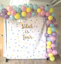 an arch made out of balloons and confetti with the words sedah is tour