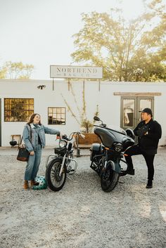 a woman standing next to a parked motorcycle and another person pointing at the bike on the ground