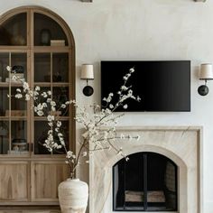 French Fireplace With Tv, Fireplace Surrounded By Windows, Modern French Country Fireplace, Arched Gas Fireplace, Fireplace With Windows On Both Sides, Marble Fireplace Living Room, Mediterranean Fireplace Ideas, Tall Fireplace Ideas, Stone Fireplace With Built Ins