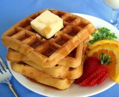 a plate with waffles and fruit on it