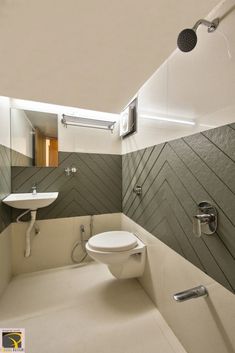 a white toilet sitting inside of a bathroom next to a sink