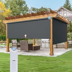 an outdoor living area with a patio, grill and pergola cover on the grass