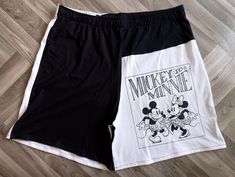 Discover the perfect blend of comfort, style, and sustainability with our black and white Mickey and Minnie unisex shorts upcycled from repurposed t-shirts at Woo's Fashion. Designed as ideal loungewear, these loose and comfy fit, boxer-style shorts feature an elastic waistband for maximum comfort. Committed to sustainable fashion, these eco-friendly shorts let you save the planet while enjoying unique, handmade gifts. Embrace the charm of Mickey and Minnie in every relaxed moment. Measurements White Patchwork Shorts For Summer, Black Patchwork Shorts, Summer Patchwork Shorts For Streetwear, Summer Streetwear Shorts With Patchwork, Summer Streetwear Patchwork Shorts, Black Patchwork Short Bottoms, White Patchwork Short Bottoms, Mickey Und Minnie, Mickey Shorts