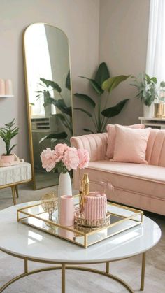 a living room with pink couches, coffee table and mirror on the wall in front of it