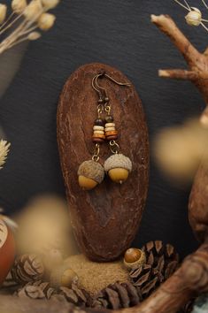 Nature jewelry lovers watch out! The forest jewelry collection is expanded by the acorn earrings. These beautiful wooden earrings are studded with real acorns, collected in the Black Forest in southern Germany and delight any hippie or boho lover. The handmade wooden jewelry pieces are a perfect gift for any nature jewelry lover. Each earring has been carefully crafted from natural materials, making them one-of-a-kind. Wear a piece of the forest on your ears with a pair of acorn earrings and show your love for nature. These ethnic earrings are versatile enough to be worn with a variety of outfits. Explore our collection of acorn earrings and wooden jewelry and find the piece of jewelry that enhances your personality. Treat yourself or a loved one to something special that is guaranteed to Cheap Brown Nature-inspired Jewelry, Luxury Brown Nature-inspired Jewelry, Tree Stump Jewelry, Boho Jewelry Earrings, Handmade Wooden Jewelry, Acorn Jewelry, Acorn Earrings, Forest Jewelry, Wood Forest