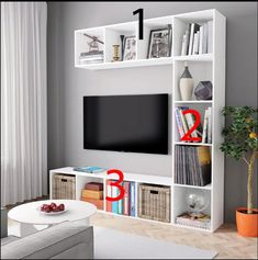 a white entertainment center with bookshelves and two red numbers on the top shelf