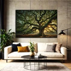 a living room with a couch, coffee table and large tree painting on the wall