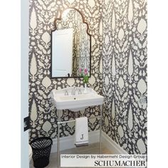 a white sink sitting under a bathroom mirror next to a wall mounted faucet