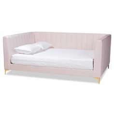 a bed that is made up with white sheets and pillows on top of the bed