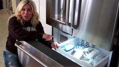 a woman is opening the refrigerator door with toothpaste in it