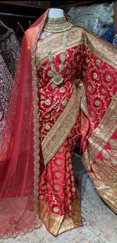 Bright red pink banarasi saree brilliantly crafted motifs in woven, stone and zardosi with zari weaved border and pallu around the drape captivates one towards it.  The saree has an unstitched blouse and a net dupatta perfect edit to your wedding rituals. Beautifully teamed with traditional pearl bridal jewelry set is Luxury Red Zari Work Dupatta, Affordable Red Dupatta With Zari Weaving, Luxury Red Saree With Intricate Embroidery, Luxury Red Dupatta In Traditional Drape, Luxury Saree With Dabka Work For Traditional Ceremonies, Luxury Red Handwork Saree, Luxury Red Traditional Wear With Zari Weaving, Luxury Wedding Saree With Woven Motifs, Luxury Red Jamawar Dupatta