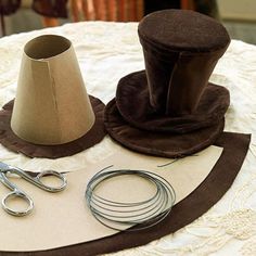 a table topped with different types of crafting supplies on top of a white table cloth