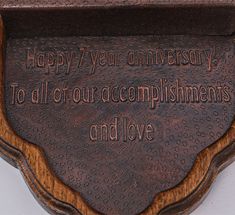 a plaque that says happy 7 year anniversary to all of our complishments and love