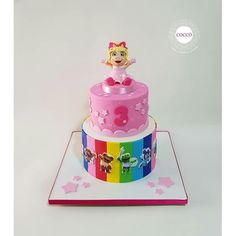 a three tiered cake decorated with an image of a cartoon character on the top