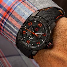 The LIV GX1-A Signature Orange features a multi-layer black dial, an Elaboré grade, 26-jewel Swiss automatic movement, a date window, a 42-hour power reserve, a 316L stainless steel black IP case with skeleton case-back, a scratch-resistant & anti-reflective sapphire crystal, a screw-down crown, and water-resistant to 100 meters. Black Chronograph Watch With Date Display For Business, Business Chronograph Watch With Date Display In Black, Modern Black Chronograph Watch With Date Display, Formal Black Chronograph Watch With Date Display, Black Chronograph Watch With Date Display, Elegant Black Chronograph Watch With Date Display, Luxury Black Chronograph Watch With Date Display, Luxury Black Chronograph Watch With Date Indicator, Modern Black Chronograph Watch With Date Indicator